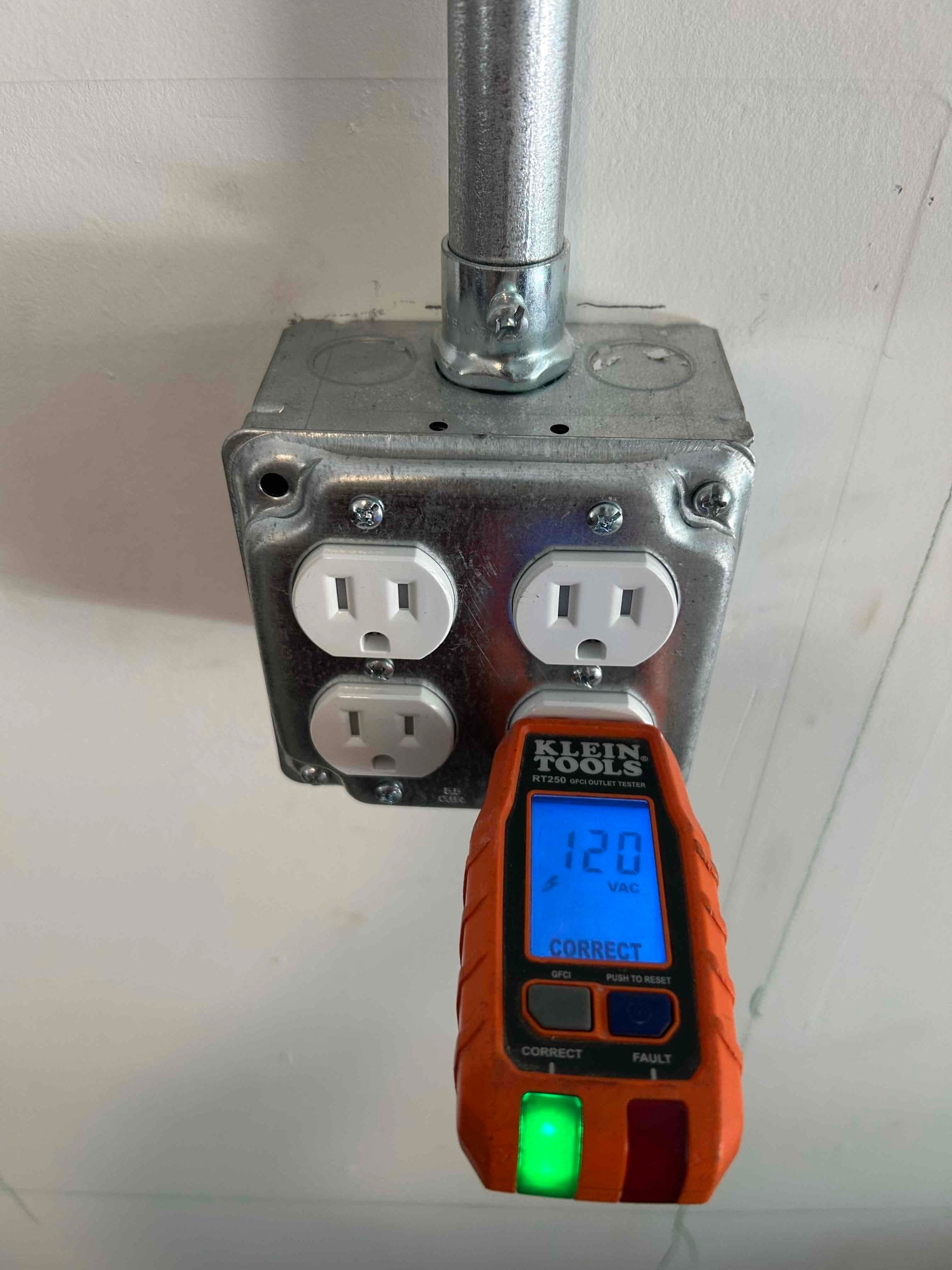Testing a newly installed GFCI outlet in a Durham garage