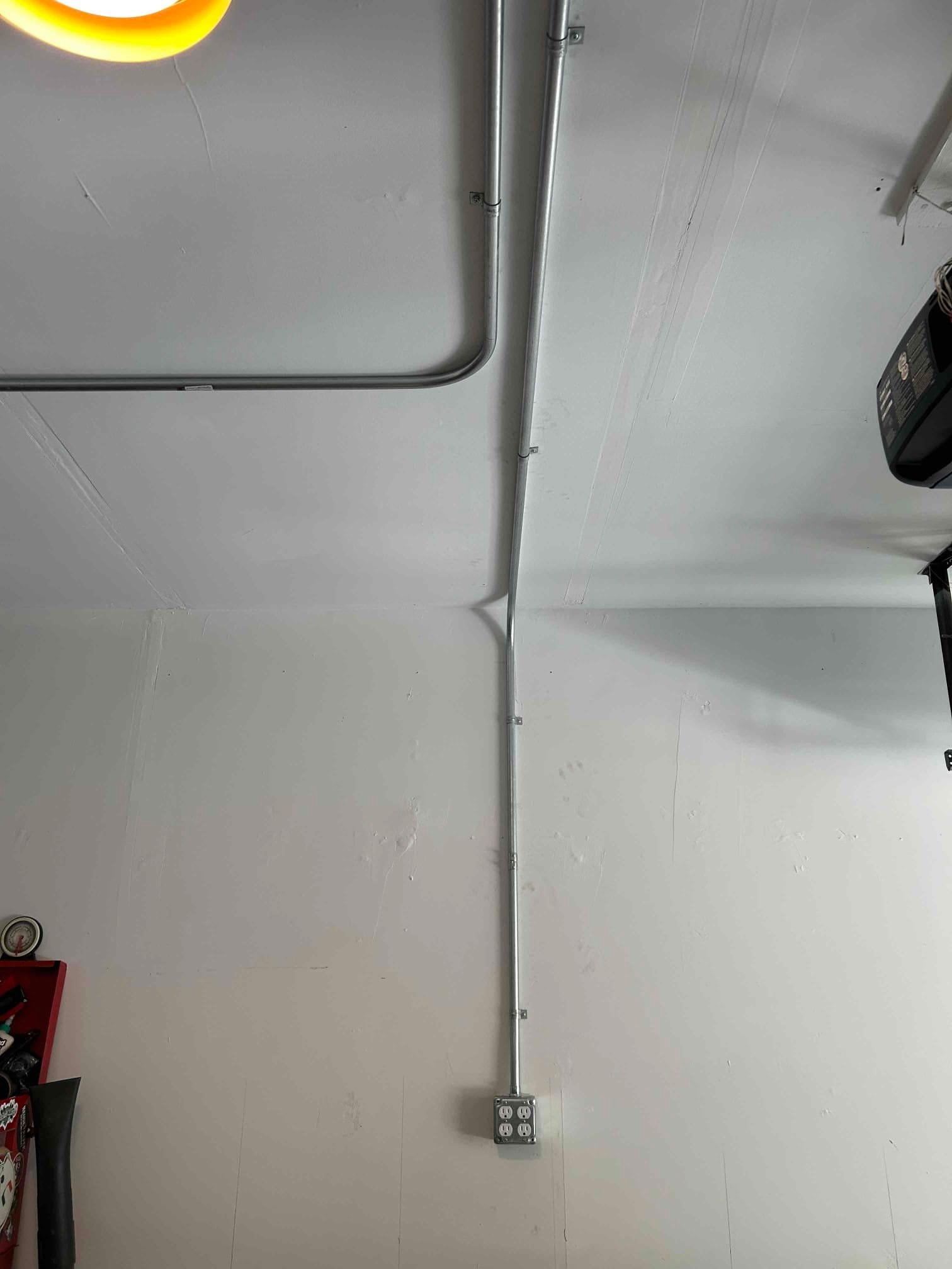 Professional metal conduit installation in a Durham garage