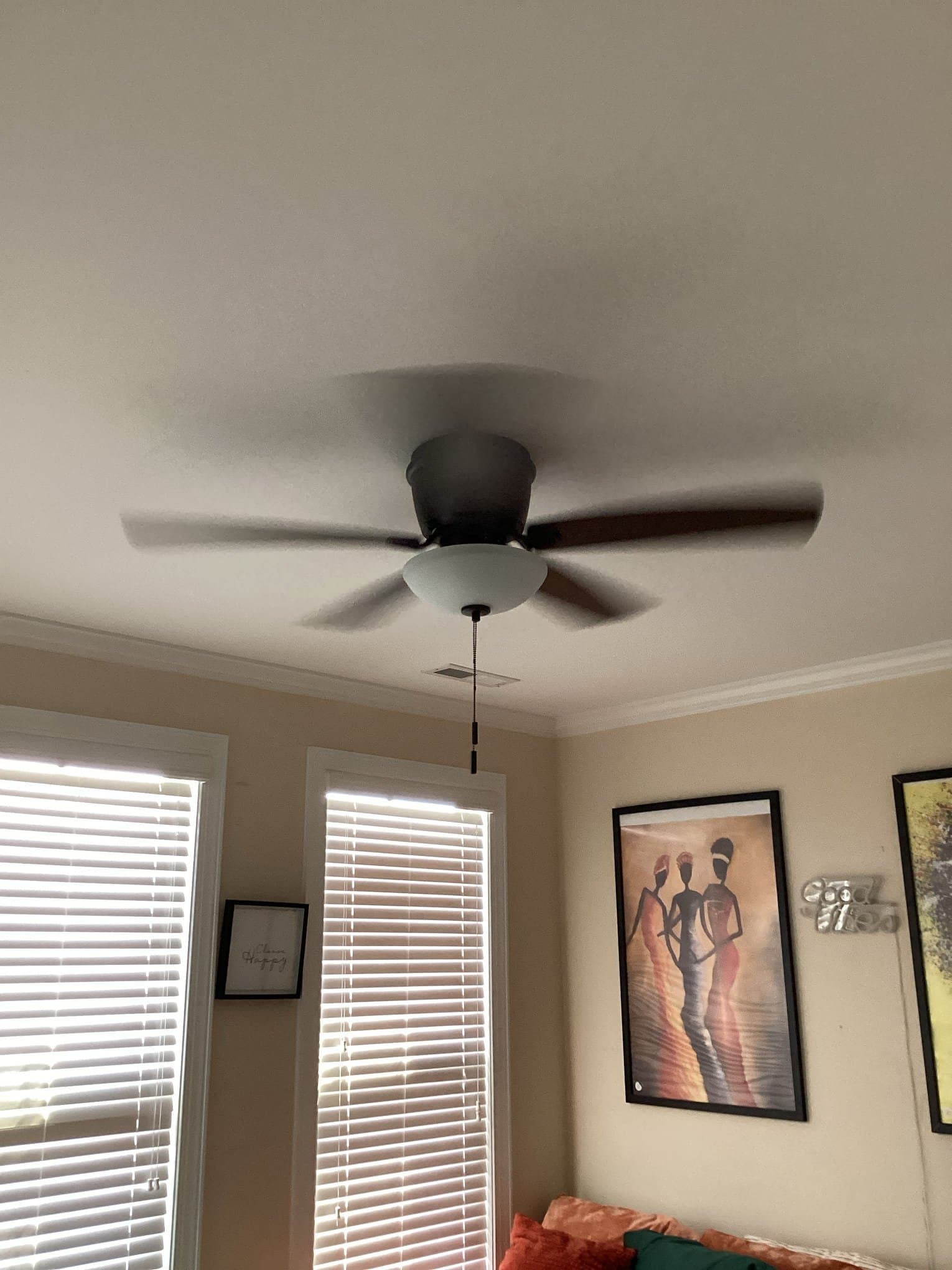 Touchstone Electric technician installing a ceiling fan