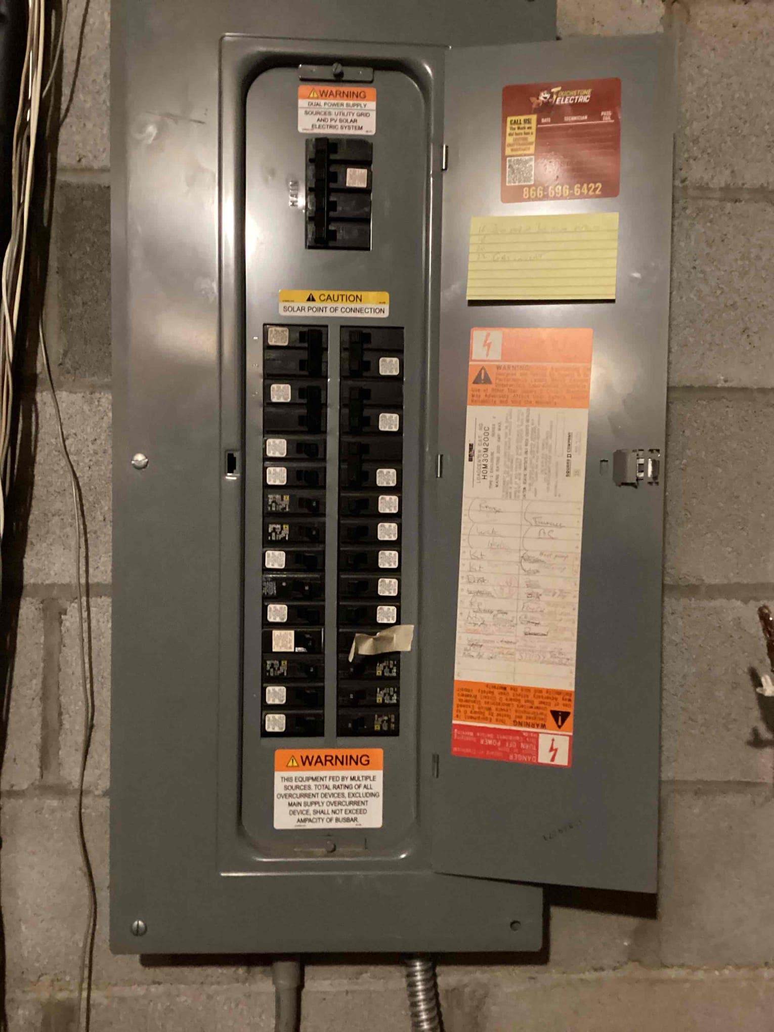 Electrician testing completed panel rejuvenation work