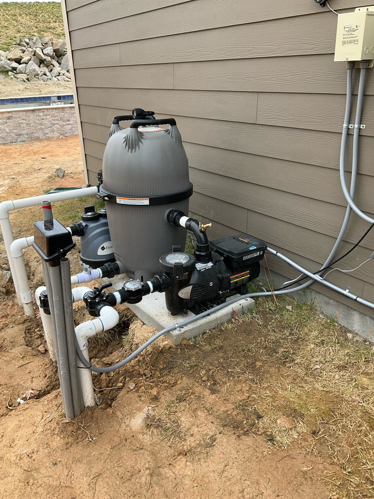 Touchstone Electric electrician reviewing outdoor electrical service equipment for pool electrical work