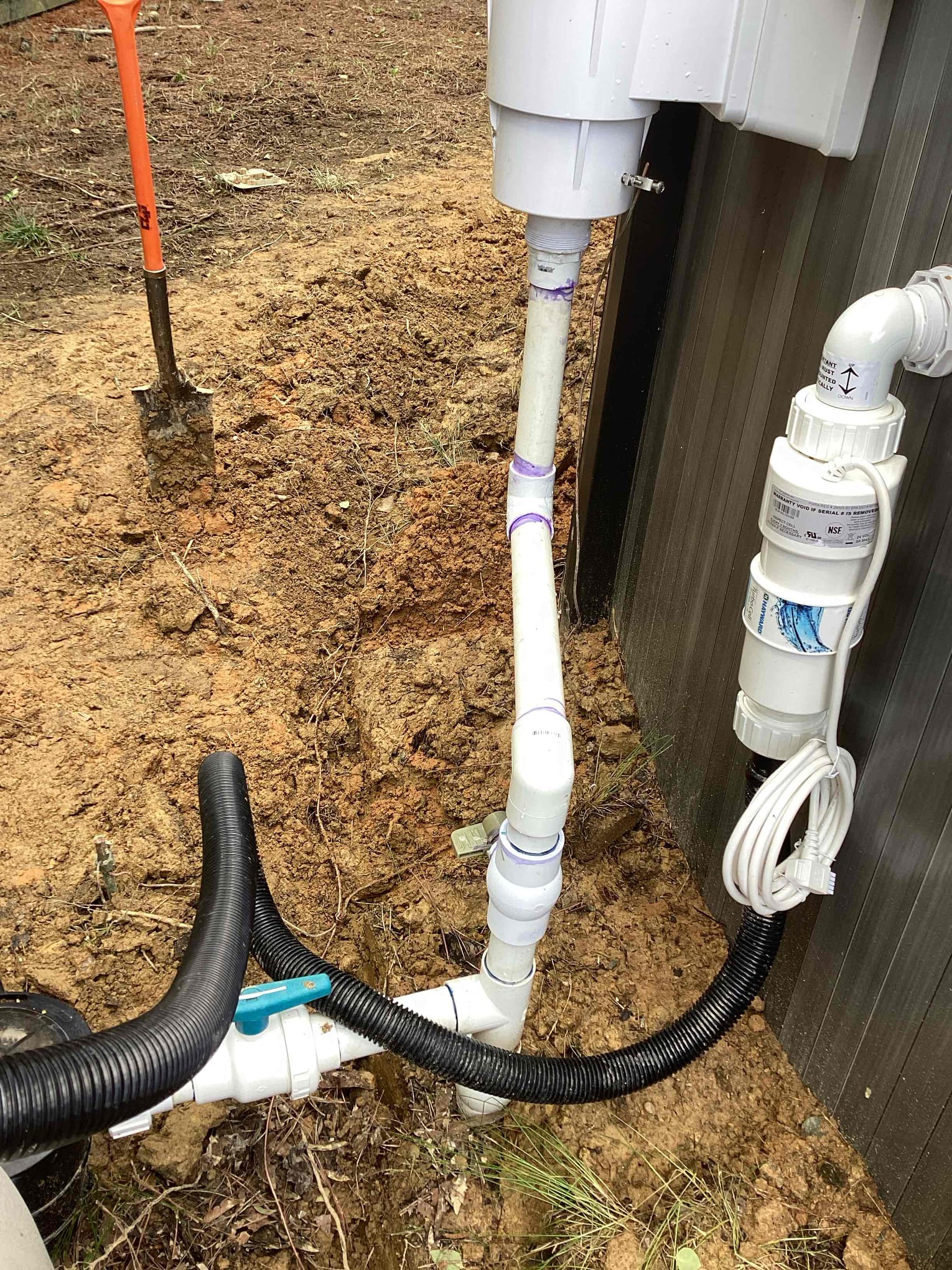 Touchstone Electric electrician reviewing outdoor electrical service equipment for pool electrical work