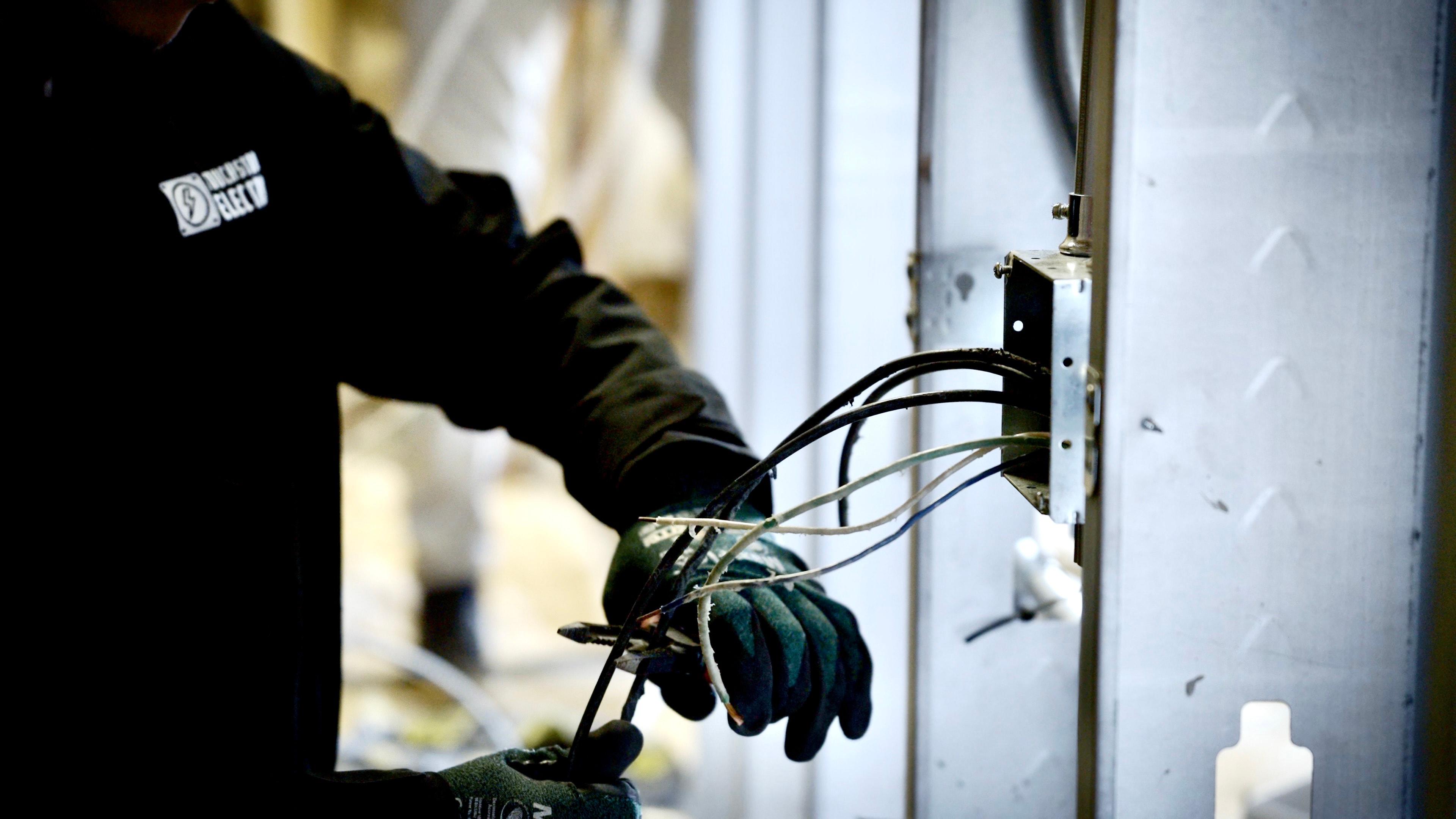 Residential electrical panel work close-up during panel replacement planning