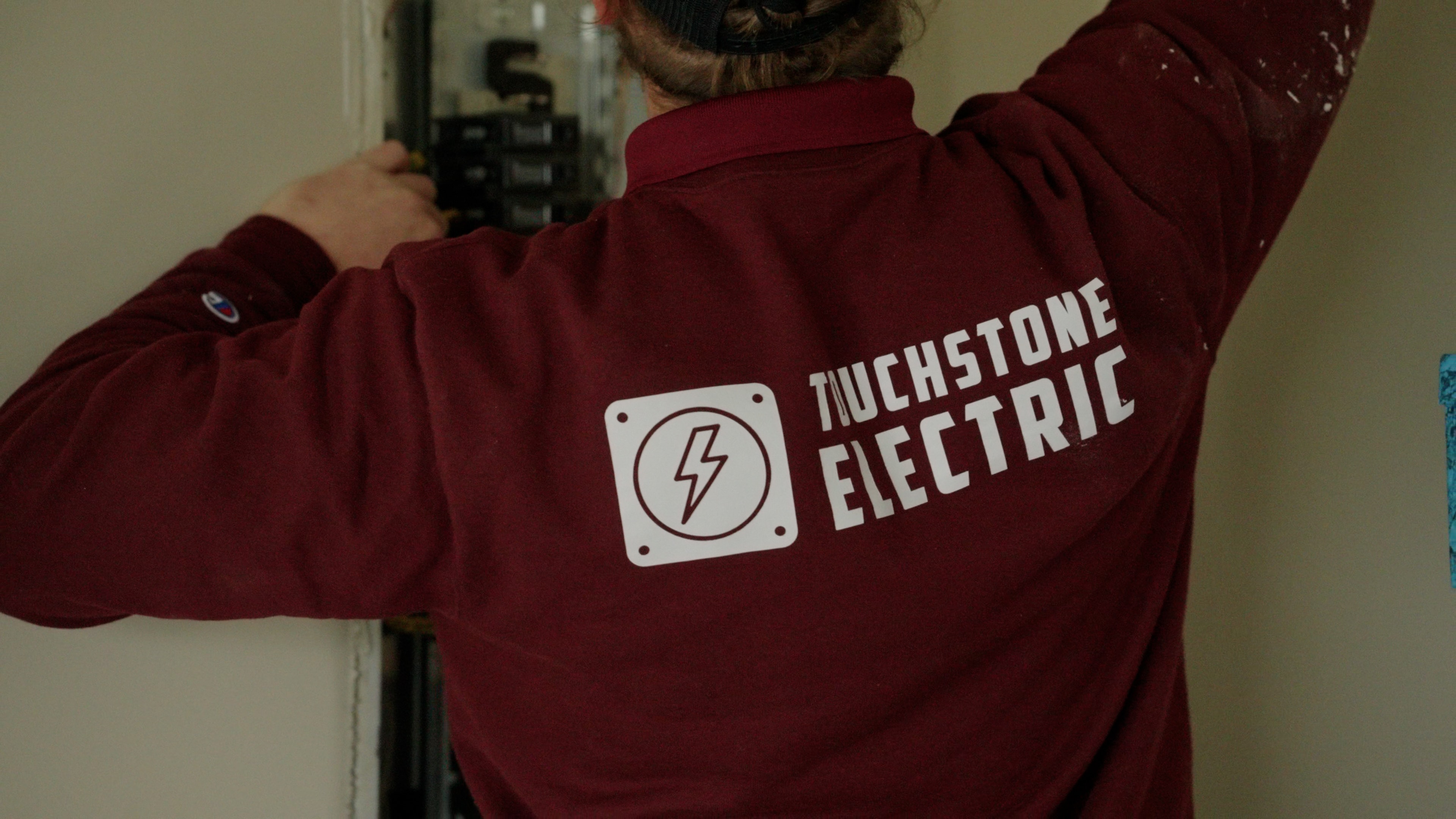 Touchstone Electric technicians installing residential service panel equipment