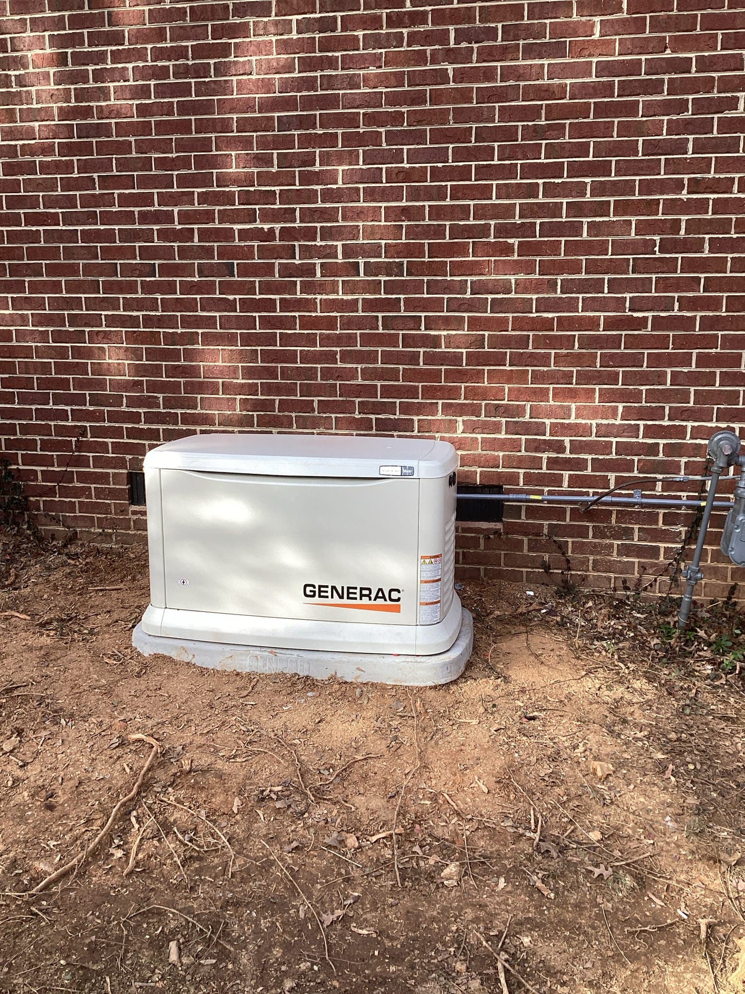 Electrician testing completed whole-home generator maintenance work